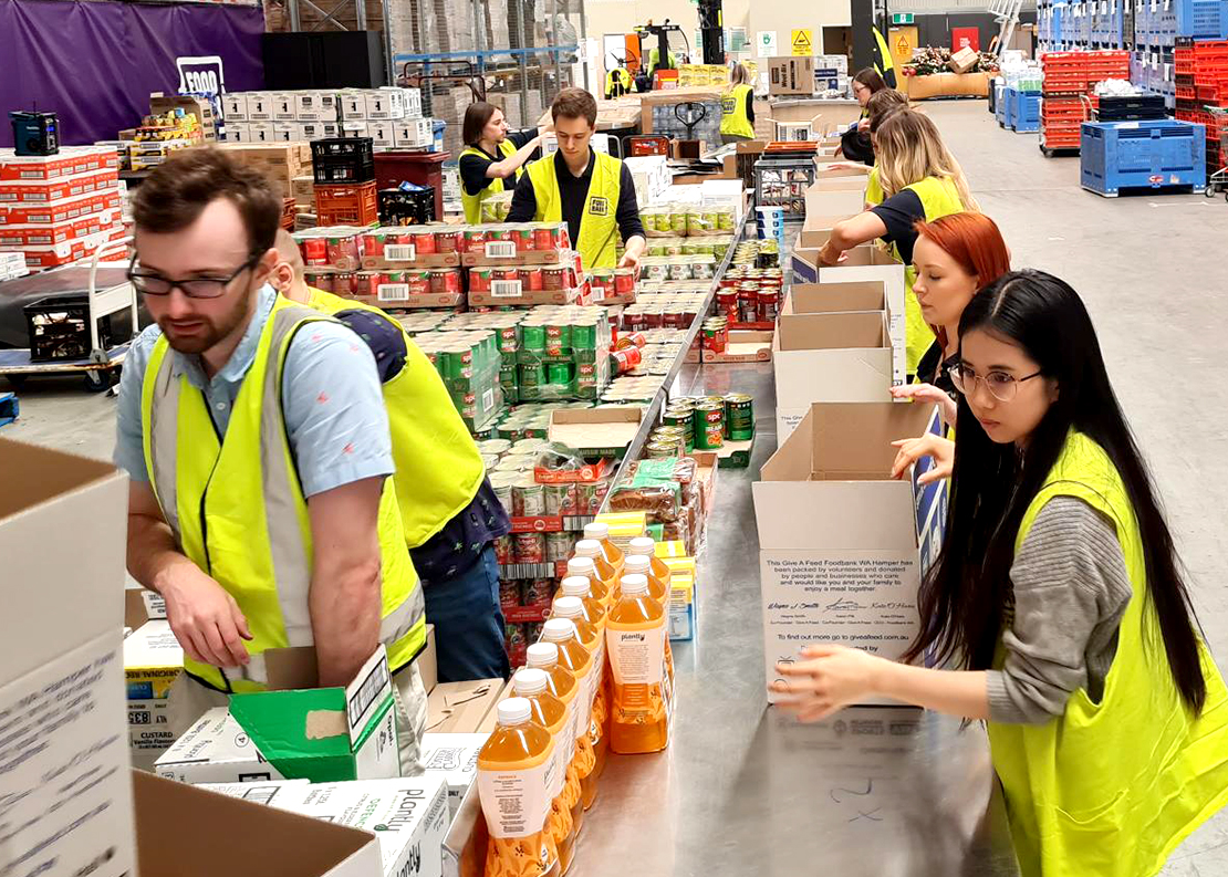 Group photo of Veritas staff packaging snack bags