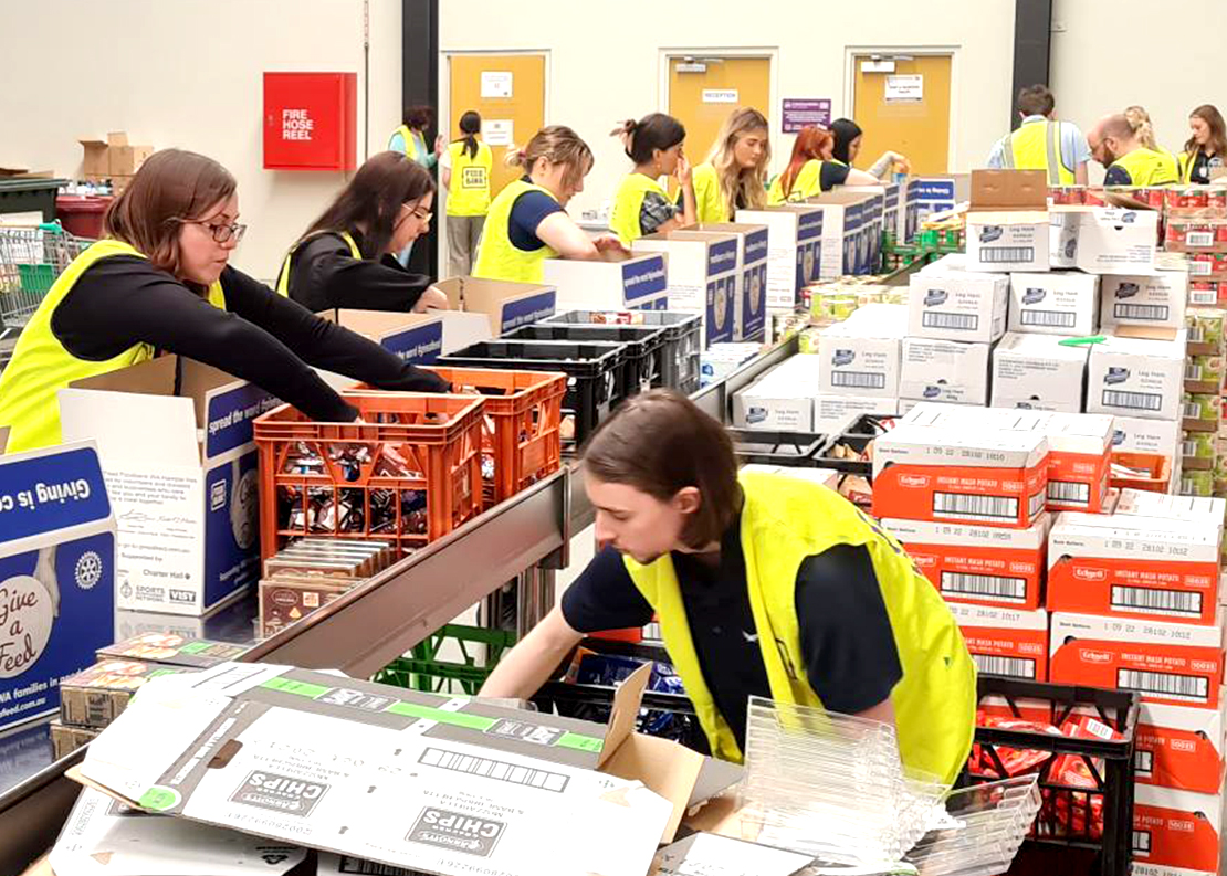 Veritas staff making boxes for the food hampers