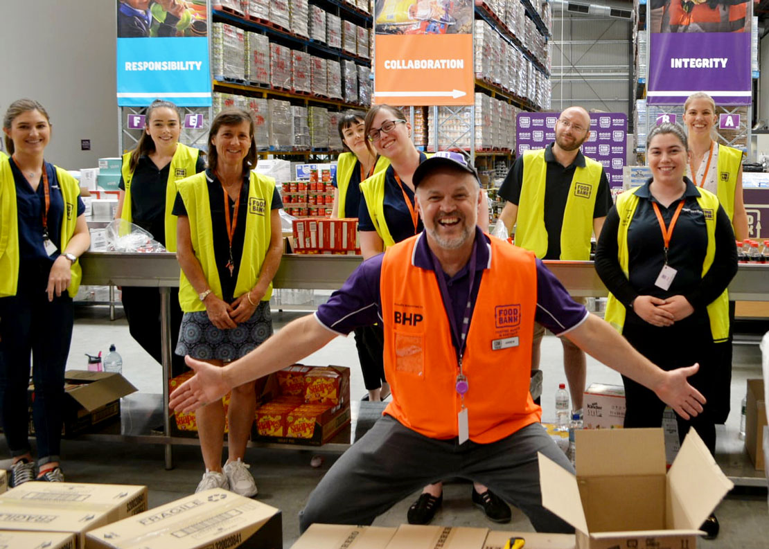 Group photo of Veritas staff packaging snack bags