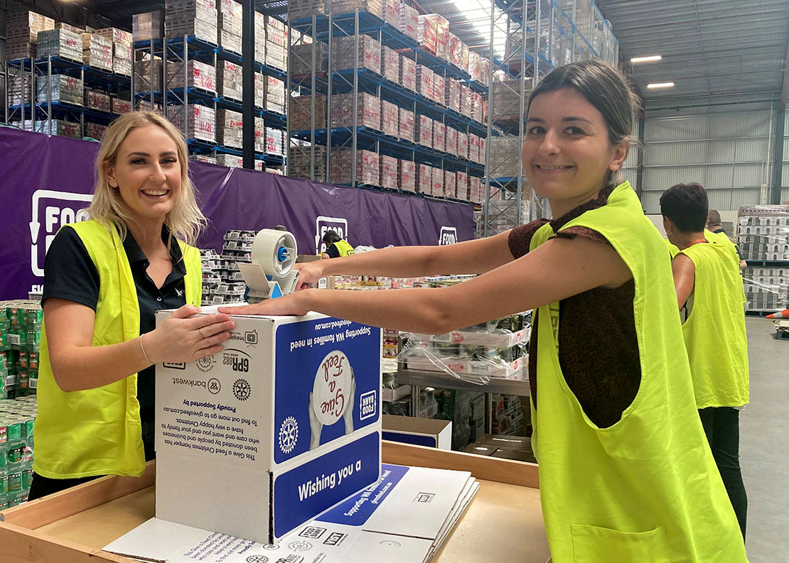 Veritas staff making boxes for the food hampers